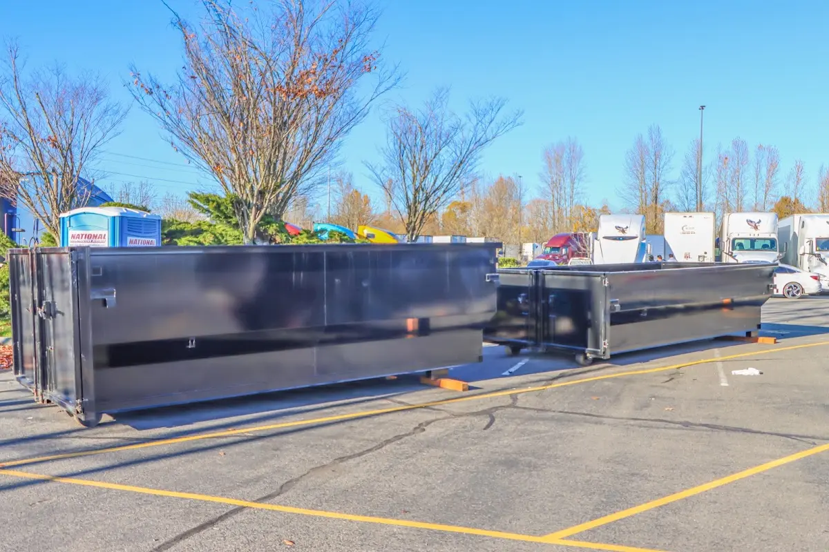 Professional dumpster rental service with roll-off container on residential driveway in San Jose